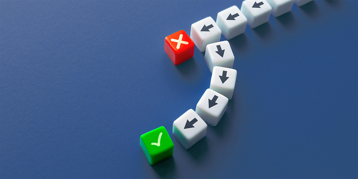 A series of dice with arrows leading to a red die with an X then rerouting to a green die with a checkmark.